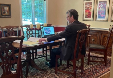 Attorney Doug Maynard sits at his dining room table preparing to argue before the NC Supreme Court on an auto insurance matter.